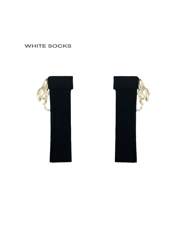 Black and white rib-knit calf socks with folded cuffs and ribbon ties
