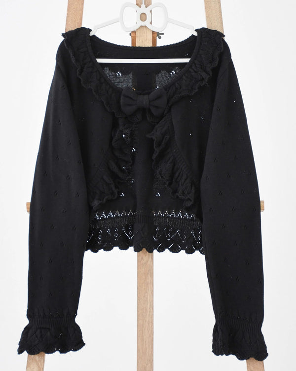 Light green knitted Lolita cardigan with openwork pattern, ruffles and bow.