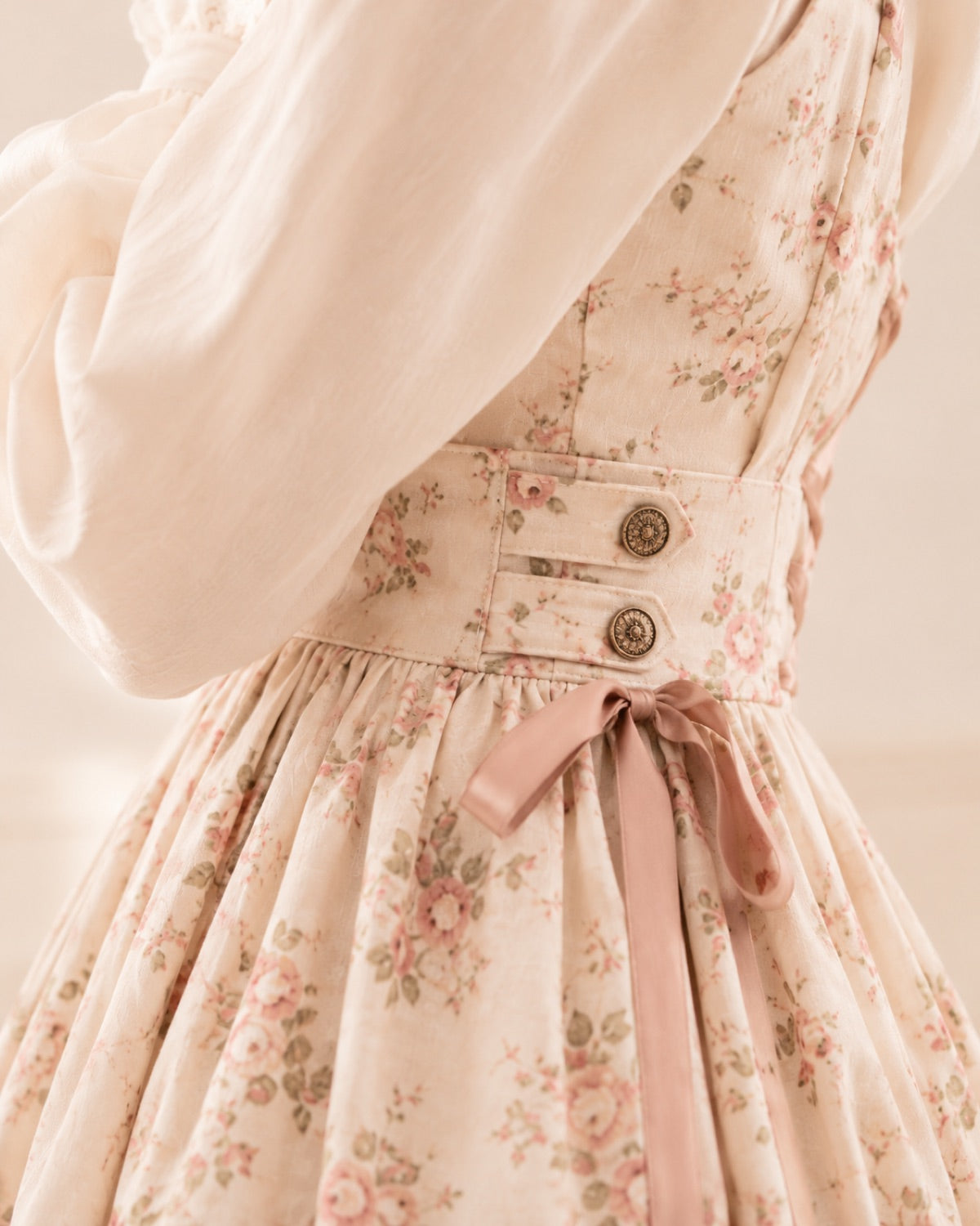 Side-waist adjustment detail on a floral Lolita dress.