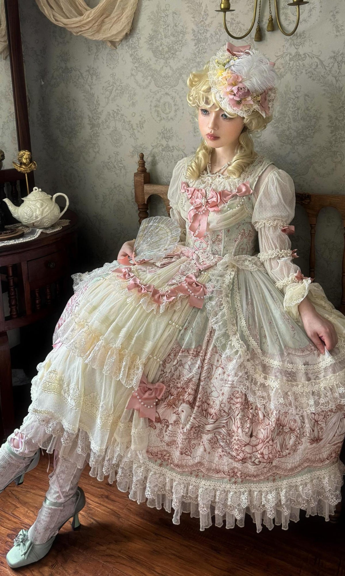 An elaborate pink and cream dress with a bonnet and layered skirt
