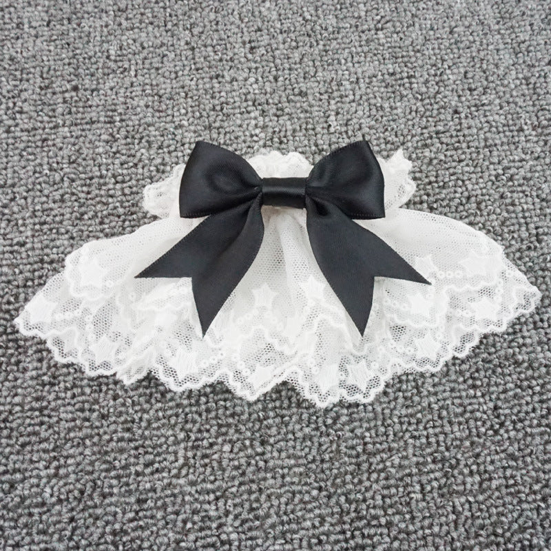 White lace Lolita cuff with a black bow