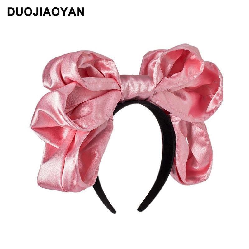 Handmade oversized satin and lace LolitaFetch hairband with bow, styled as a cute Lolita fashion headwear accessory.