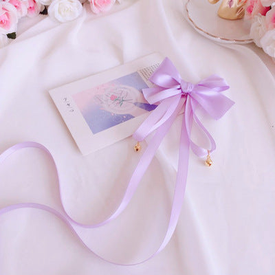Girl's Lolita bowknot long ribbon bell hair clip with cute, decorative design, perfect as a sweet headdress accessory.