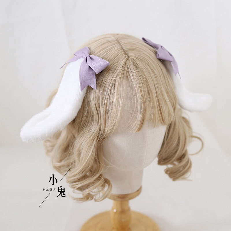 Handmade Sweet Ears Lolita bunny ear bowknot hair clip on a LolitaFetch OP dress, featuring pink and white fabric with bow details.