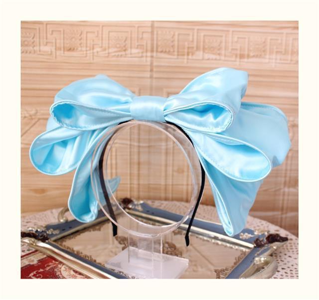 Handmade oversized satin and lace Lolita hairband with bow, styled on a mannequin head, by LolitaFetch.