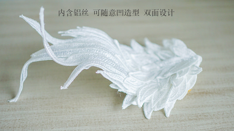 Black and white embroidered angel wings LolitaFetch hair clip styled as a feathered headdress with two-tone design and intricate details.