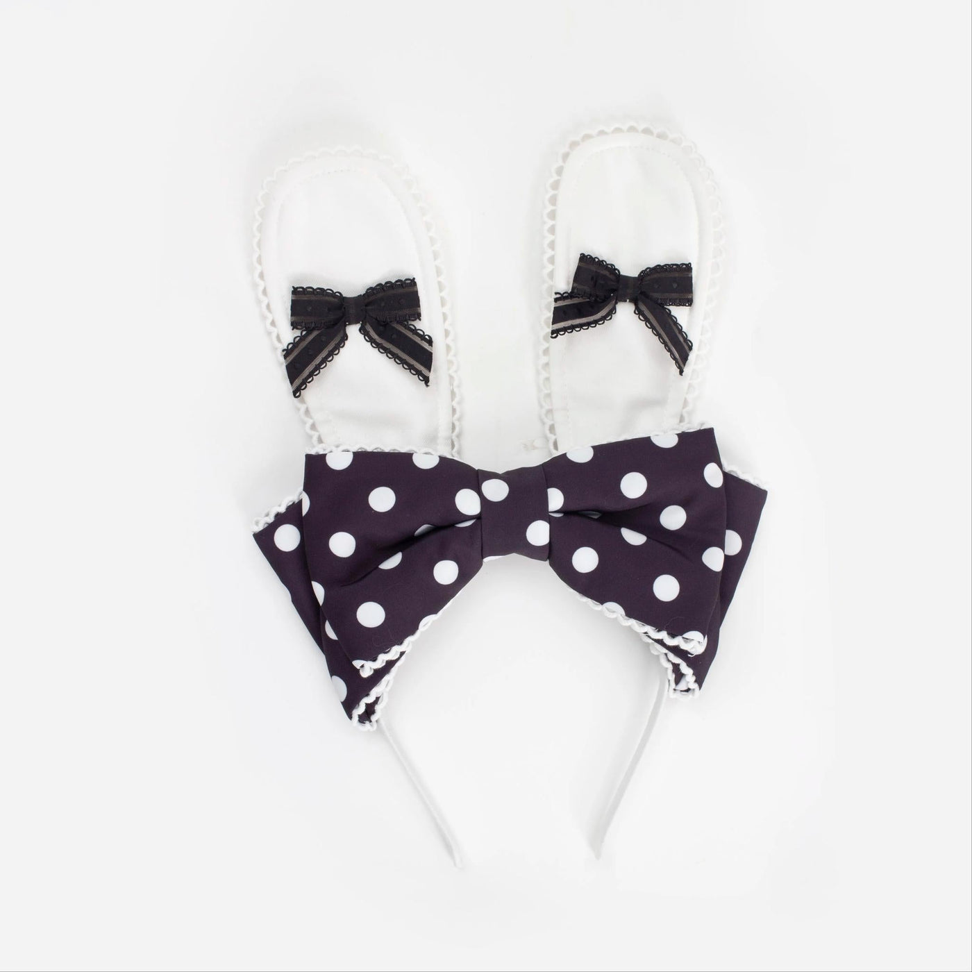 Black-and-white polka-dot bunny-ear apron with an oversized bow and lace trim.