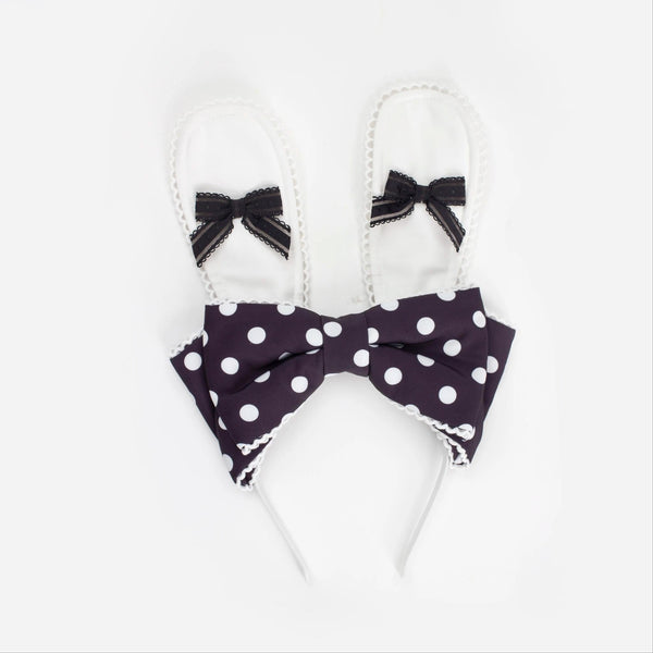 Black-and-white polka-dot bunny-ear apron with an oversized bow and lace trim.