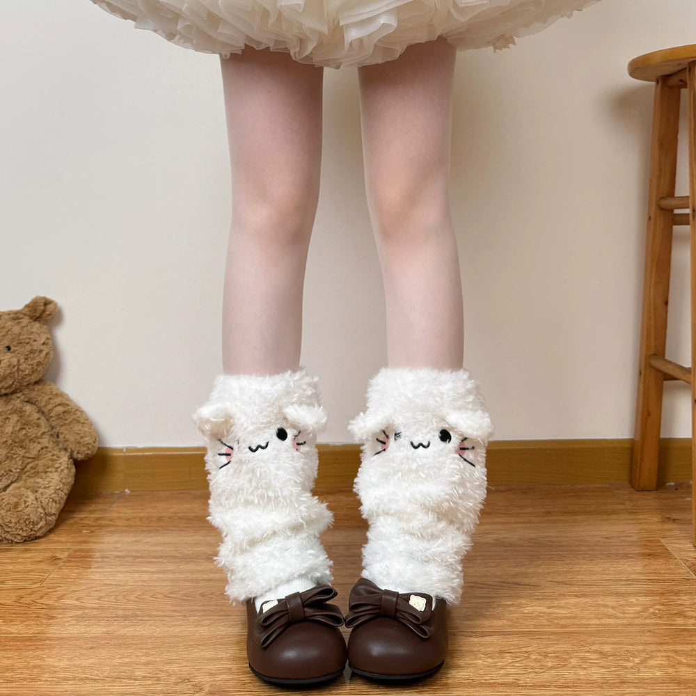 White plush leg warmers with little cat faces worn above brown bow shoes