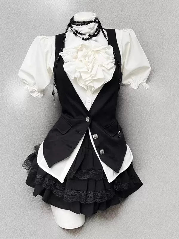 Black-and-white blouse, vest and short skirt set shown front and back on a dress form.