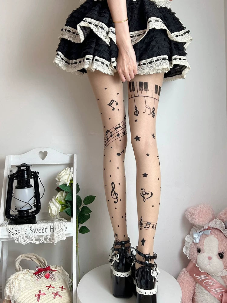 Printed tights with music notes, stars and cross motifs styled beneath a black skirt.