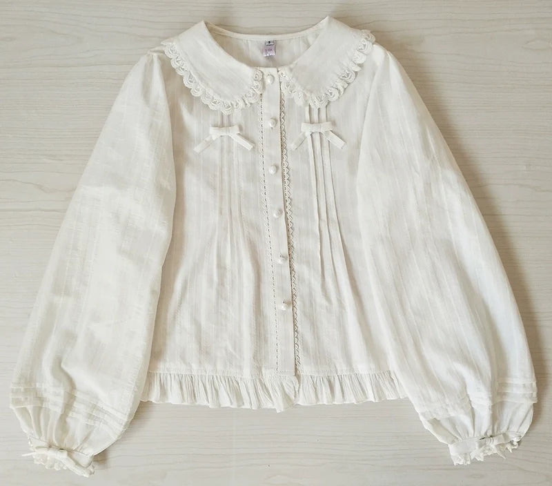 White long-sleeve Lolita blouse with Peter Pan collar and ruffle trim.
