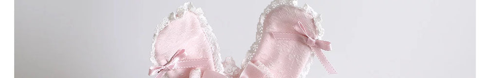 Pink rabbit-ear headwear, veils, and lace accessories shown on mannequin displays.