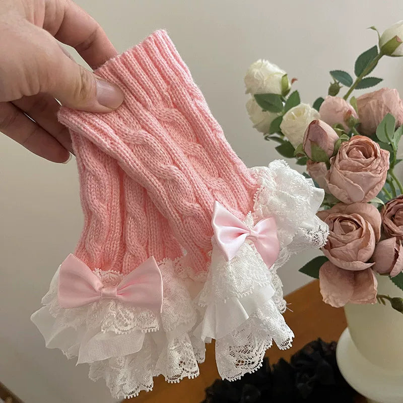 White Sock Noble cable-knit arm sleeve with lace trim and a bow.