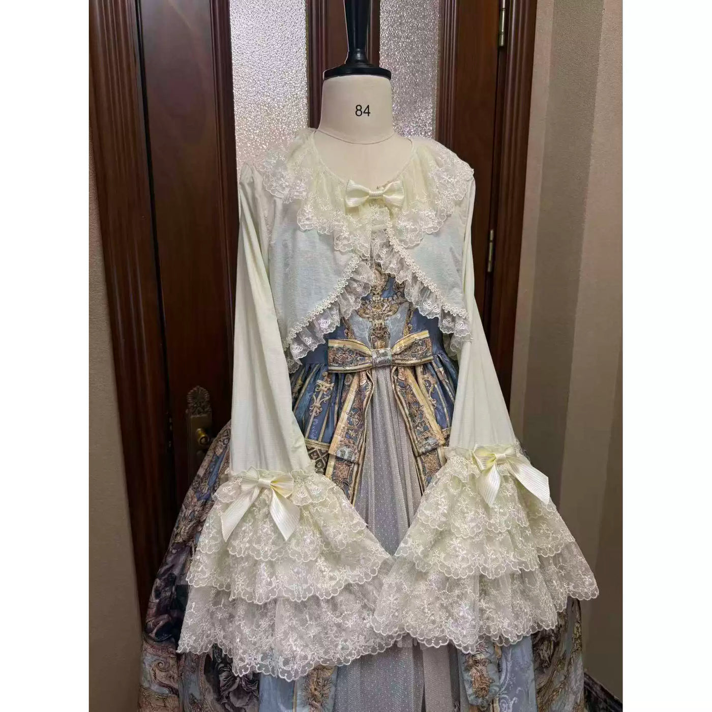 Lace-trimmed cover-ups in white, beige, pink, brown and black hanging on a clothing rack.