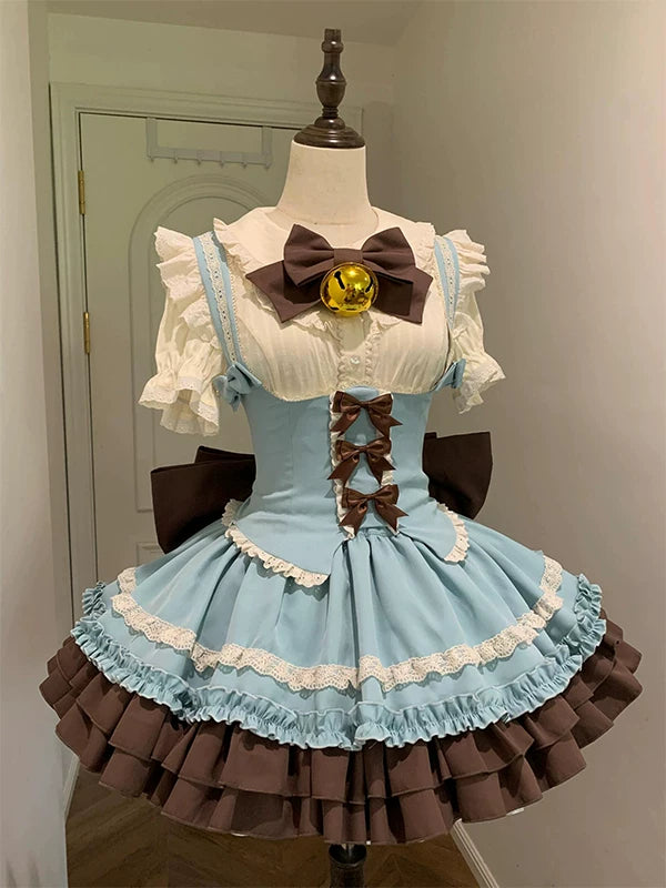 Pale blue and brown five-piece JSK set with lace trim, layered skirt, bows and a bell accent displayed on a mannequin.