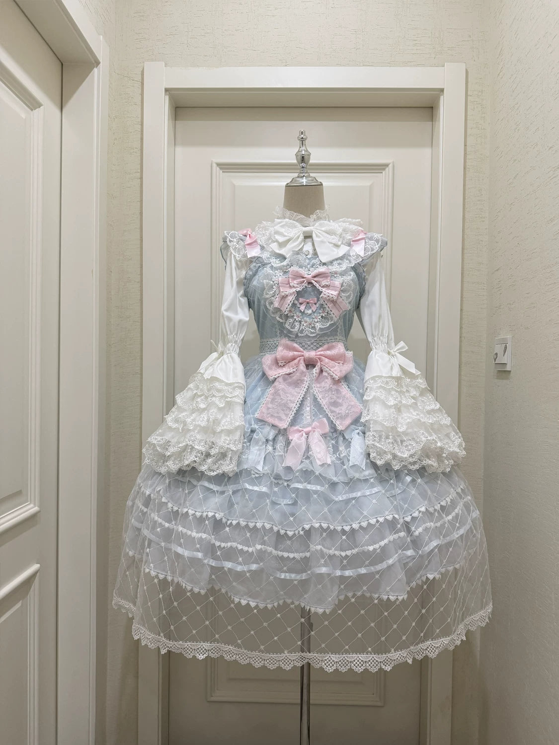 Lady Han Camellia Cherry Overture Sweet JSK dress featuring a floral cherry blossom and camellia print, showcased on a dress form.