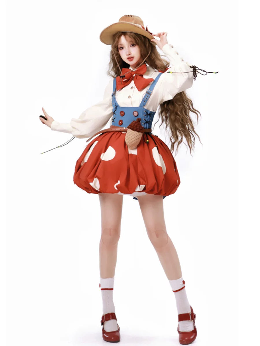 Red mushroom-print jumper skirt with blue suspenders, white blouse and tan hat