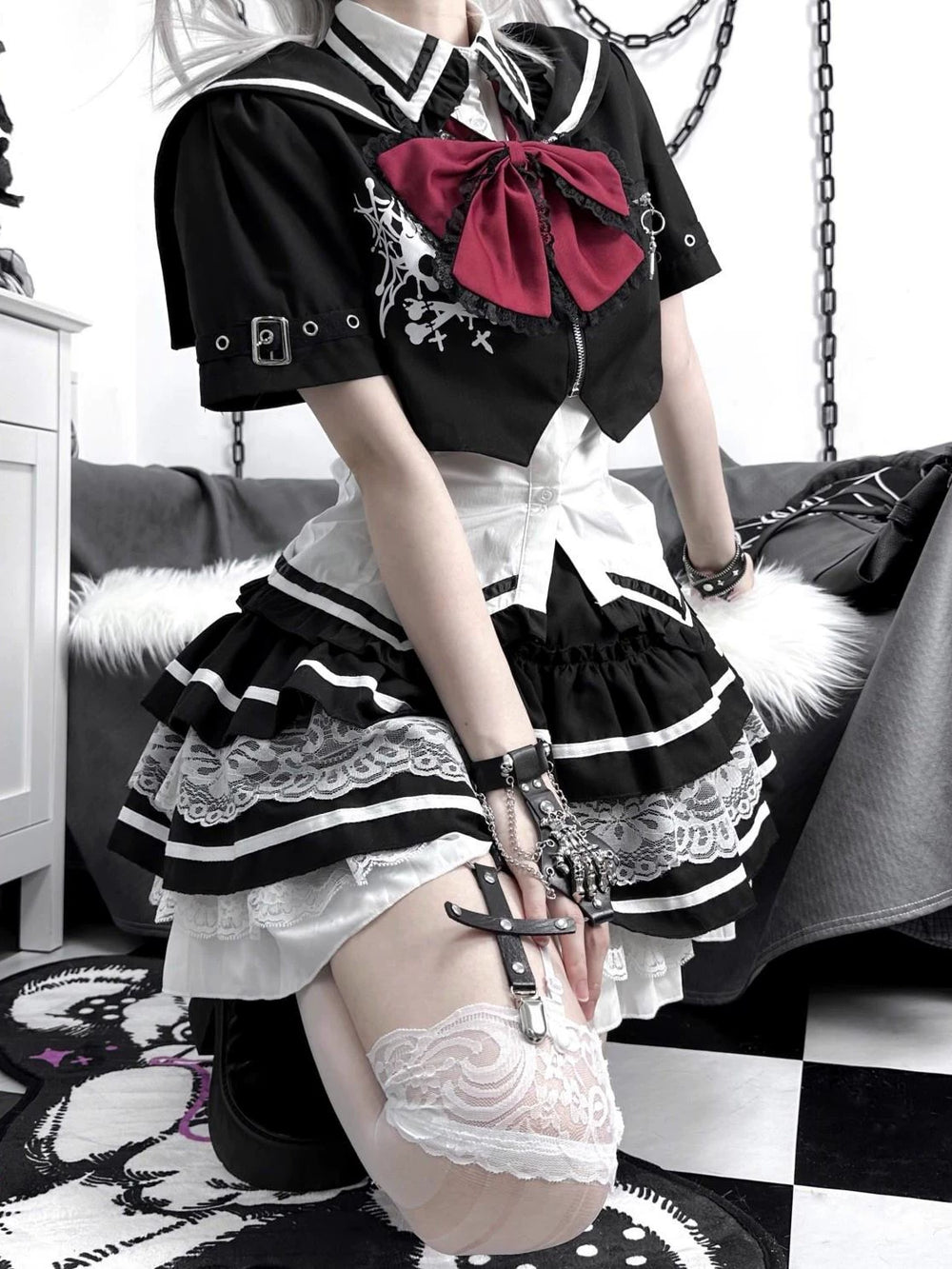 Black-and-white Gothic punk coordinate with lace trim and a fitted waist, shown on a model.