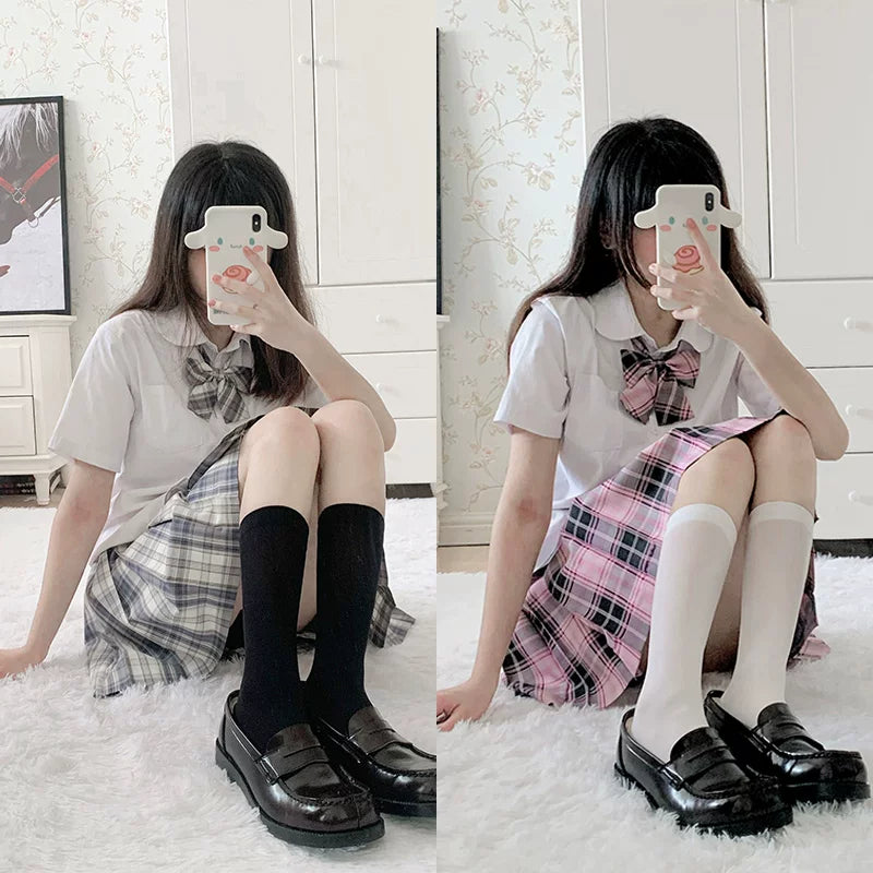 Black and white calf socks styled with plaid skirts and black platform loafers.