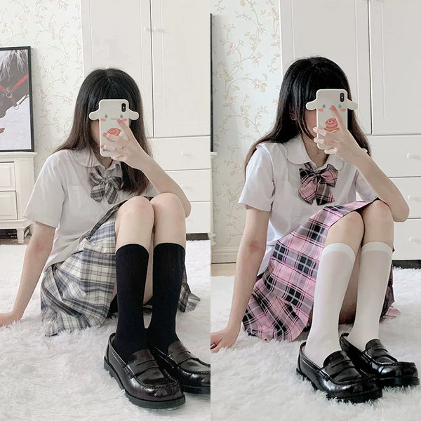 Black and white calf socks styled with plaid skirts and black platform loafers.