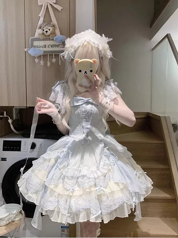 Creamy blue JSK dress with a chest bow and layered train shown in mirror photographs.