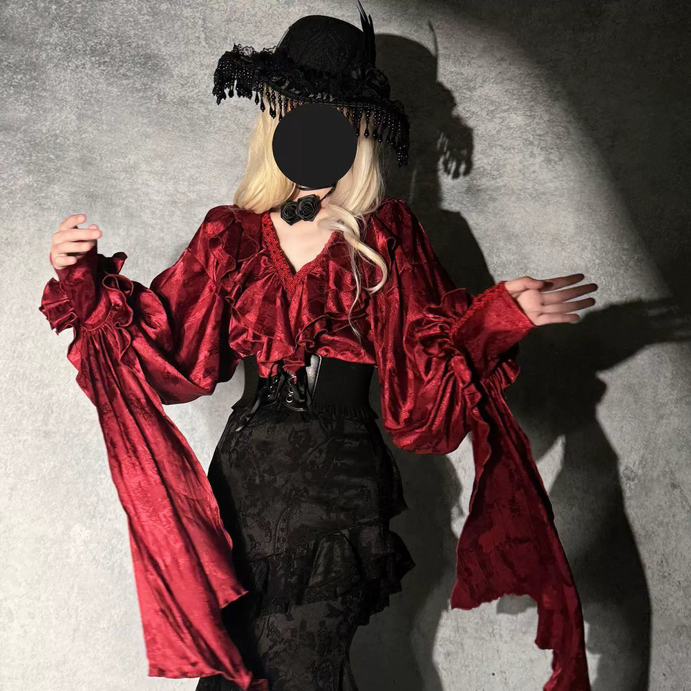 Red ruffled blouse with black fishtail skirt, waist cincher, and neck accessory