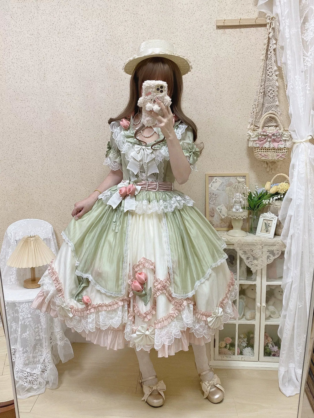 Green-pink Lolita dress with layered lace, pink rose accents, and a full skirt.