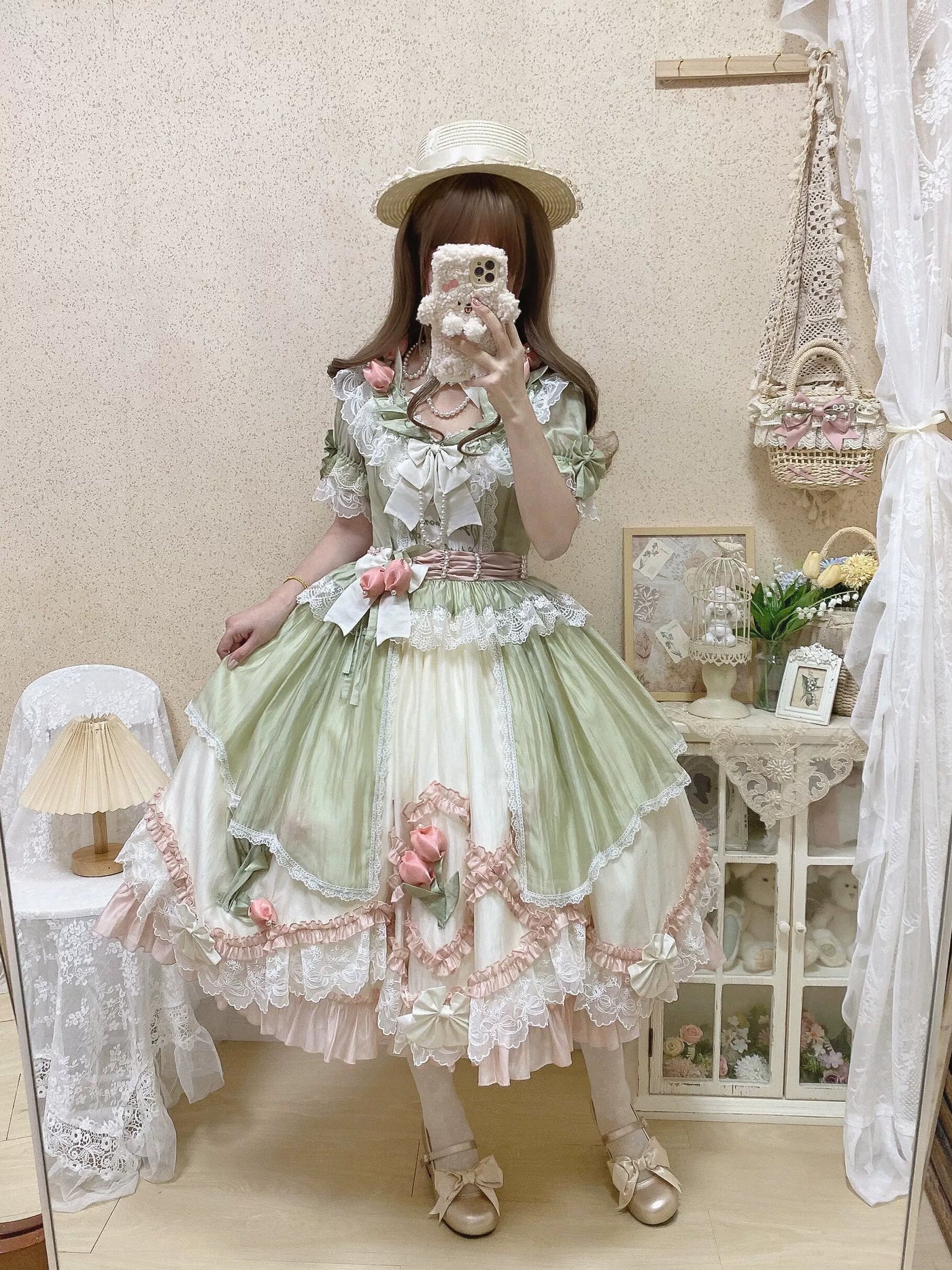 Green-pink Lolita dress with layered lace, pink rose accents, and a full skirt.