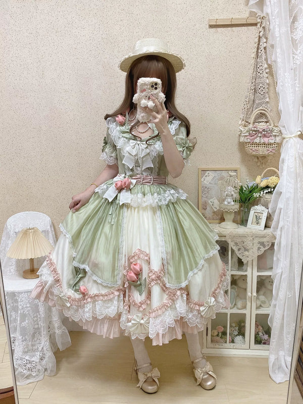 Green-pink Lolita dress with layered lace, pink rose accents, and a full skirt.
