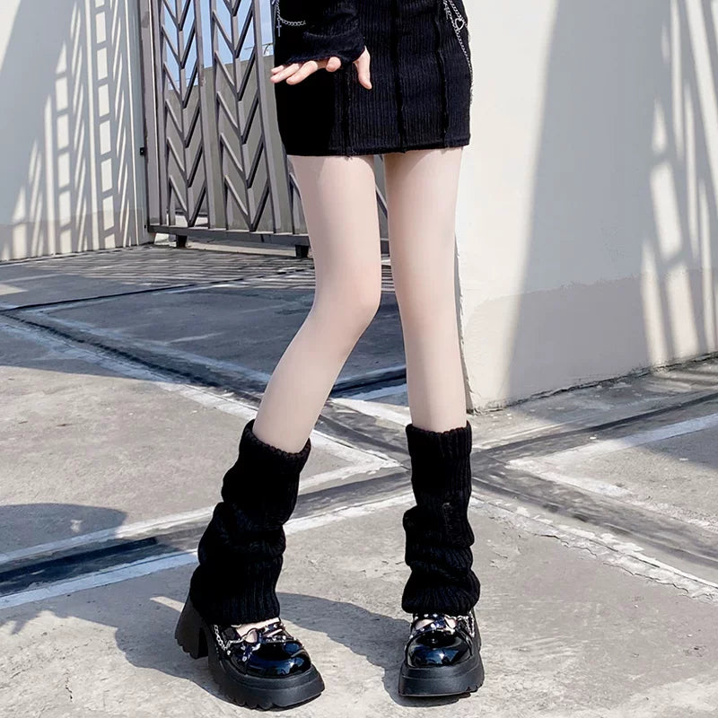 Black ribbed slouch leg warmer socks gathered over platform shoes.