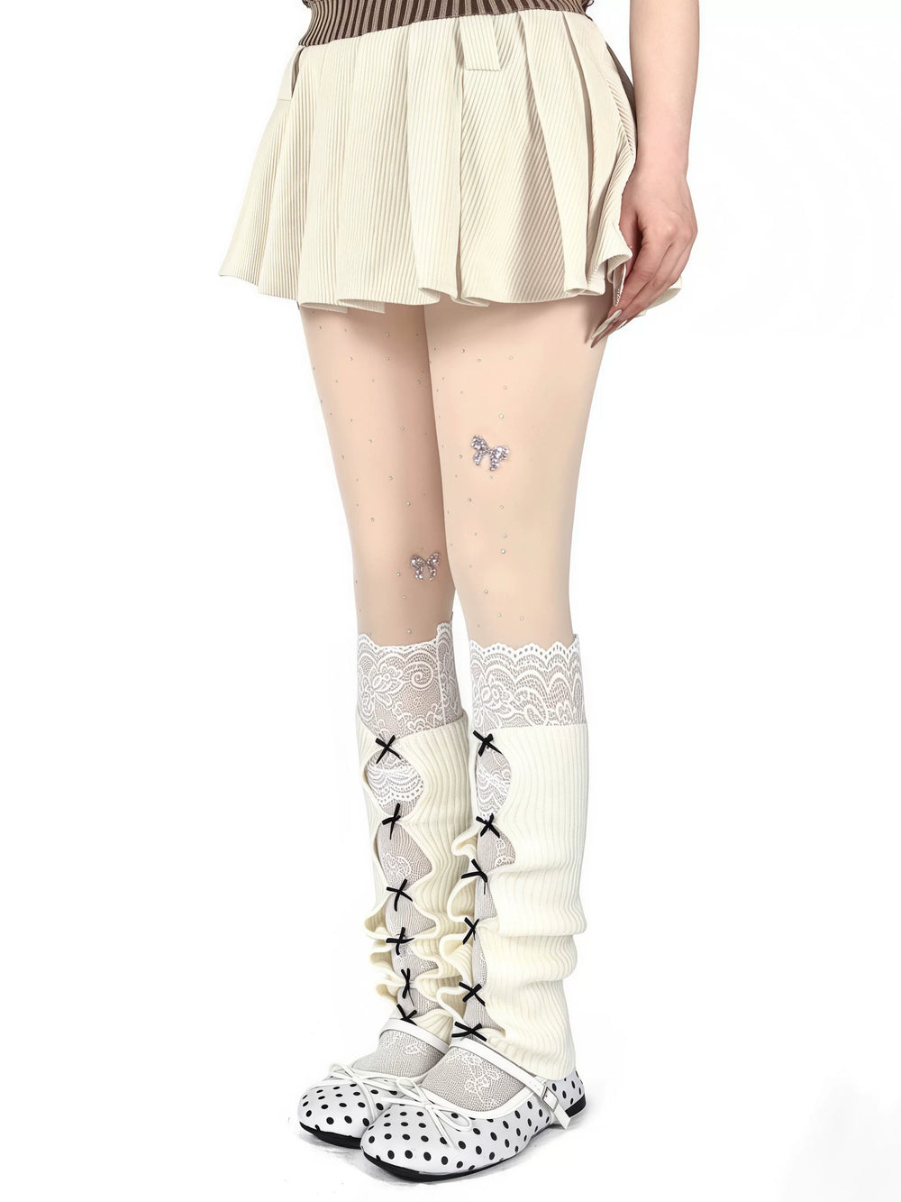 White ribbed leg warmers with lace cutout panels and black bows worn over stockings.