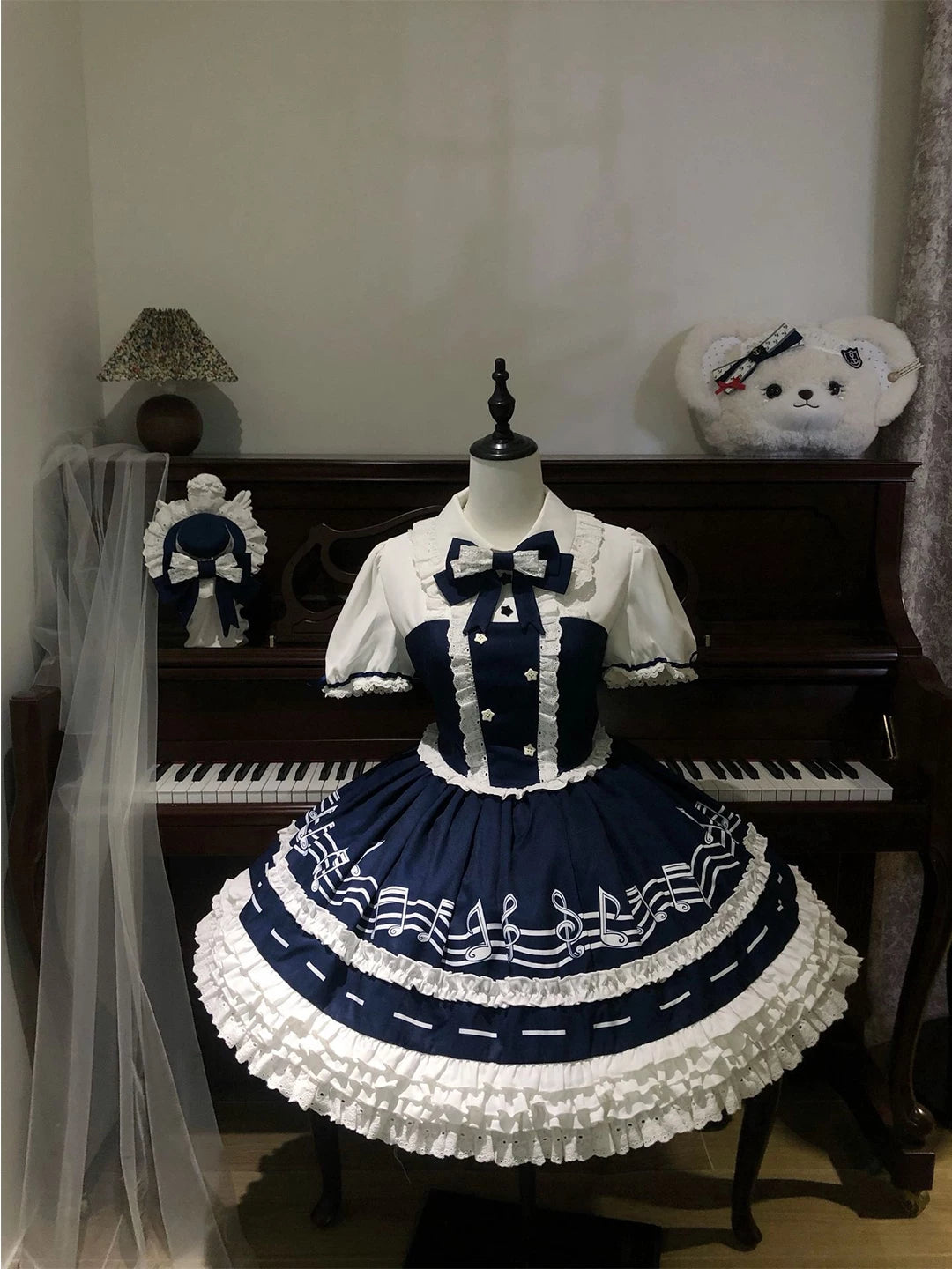 Navy-and-white OP dress with musical-note skirt print and lace trim