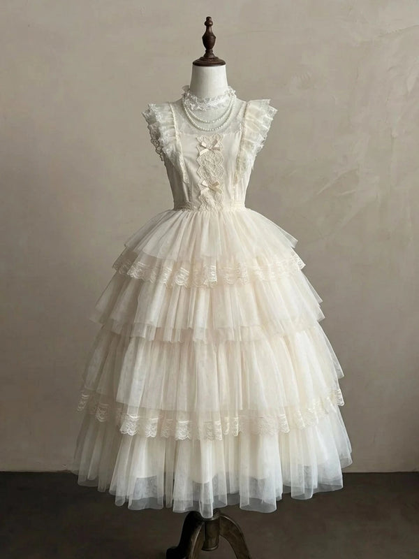 Ivory tiered lace dress with ruffled shoulder straps on a mannequin