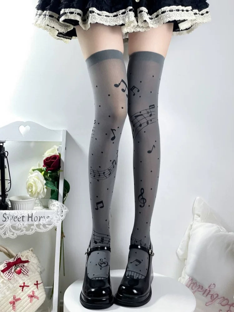 Grey over-the-knee socks printed with music notes and dots