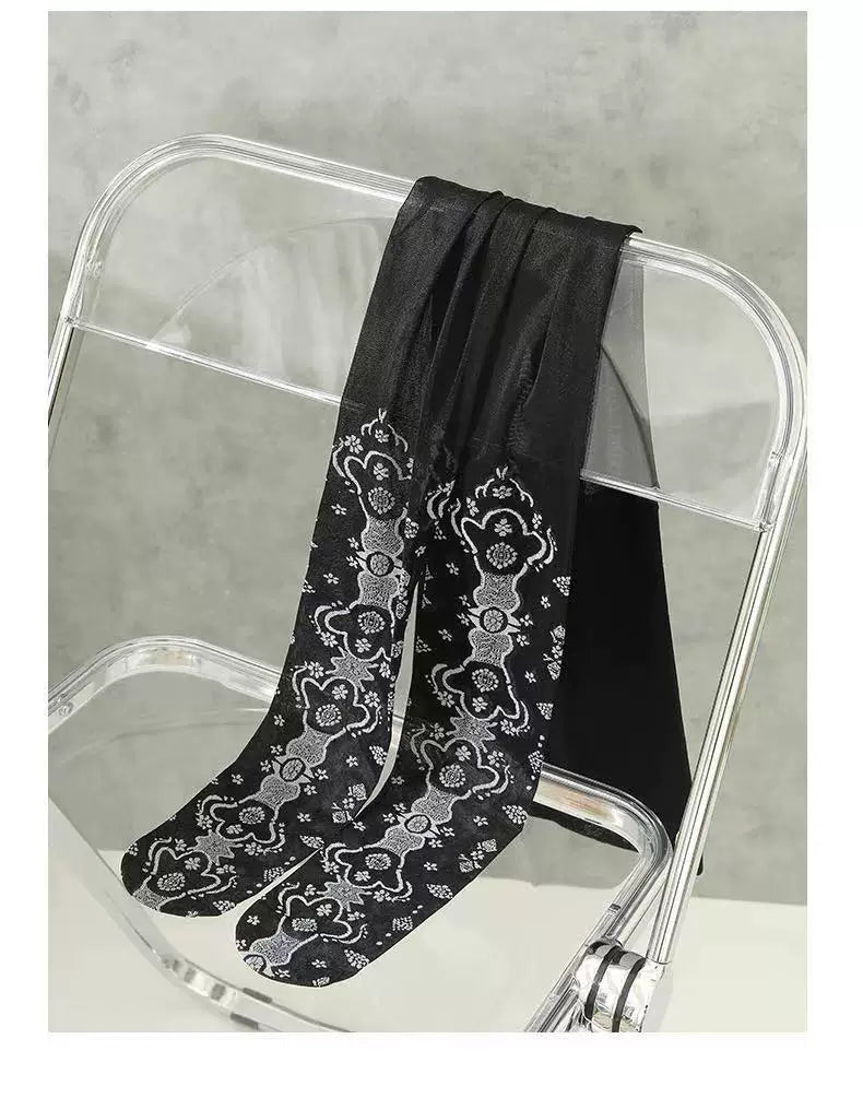 Black patterned tights draped over a clear chair.