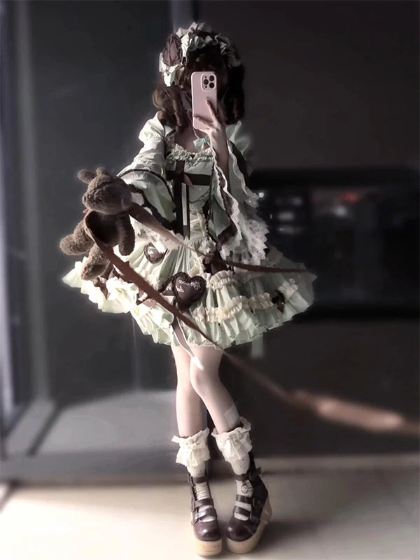 Model wearing a mint-and-ivory JSK dress with a princess-sleeve vest and head accessory.