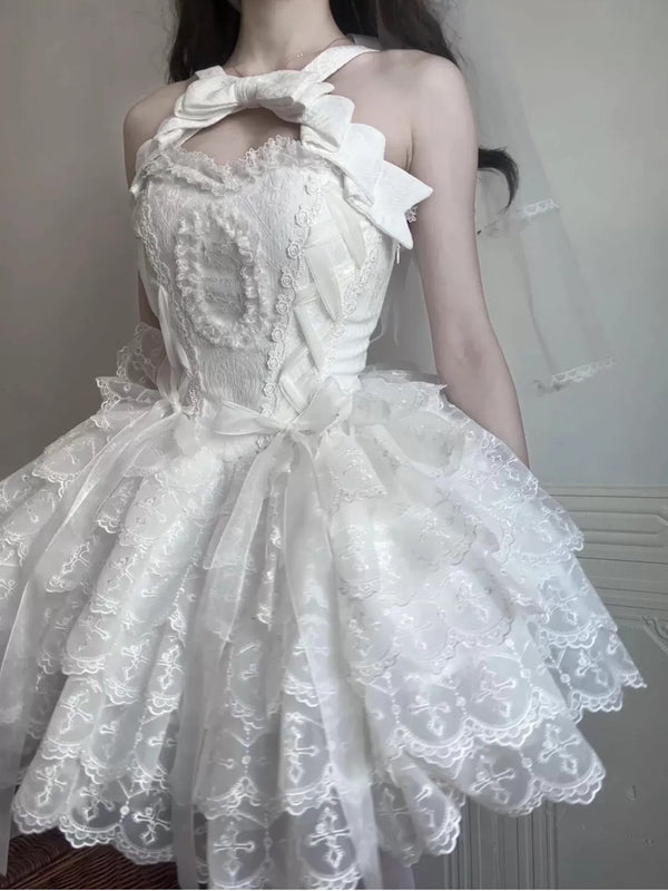 White halter-neck Lolita dress with an oversized bow and layered lace skirt.