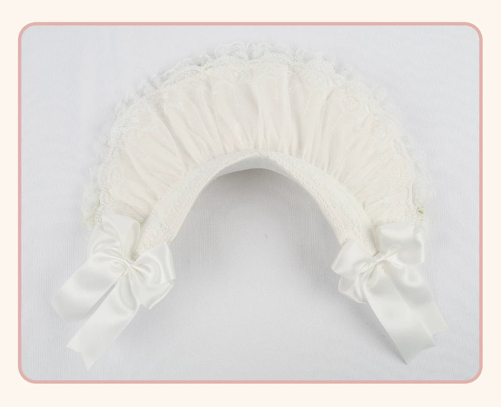 White lace-trimmed flat hat with a pleated crown and long side bows, shown flat.