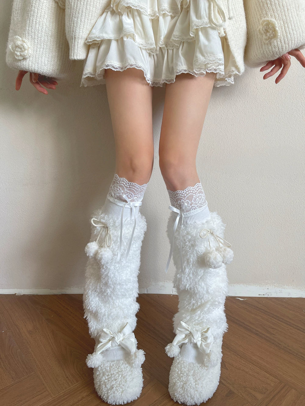 White socks and plush sock covers with lace trim and ribbon ties