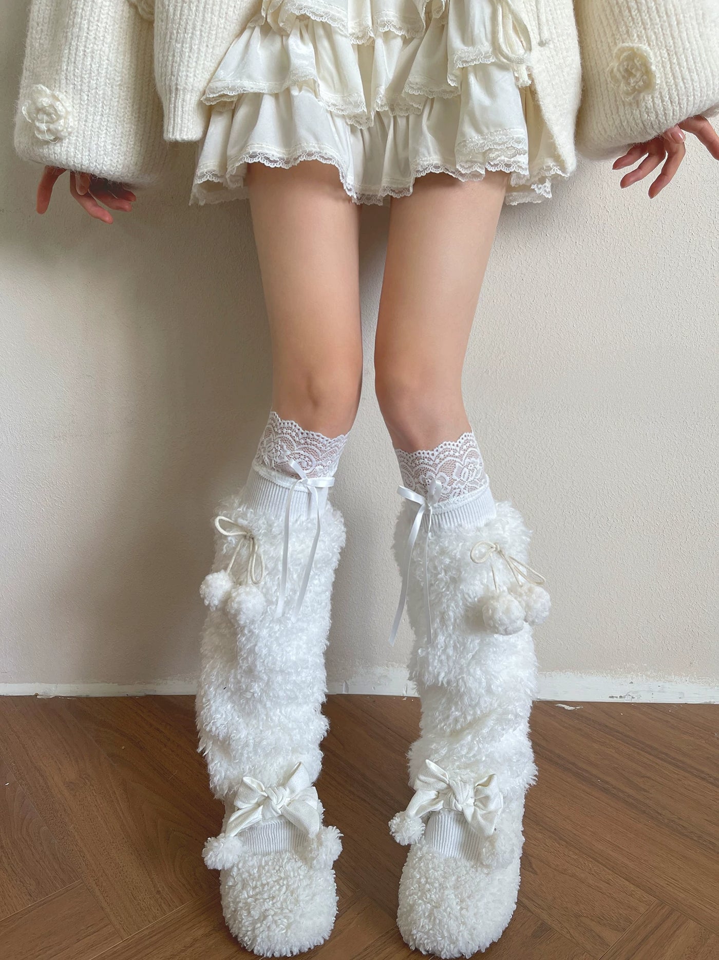 White socks and plush sock covers with lace trim and ribbon ties