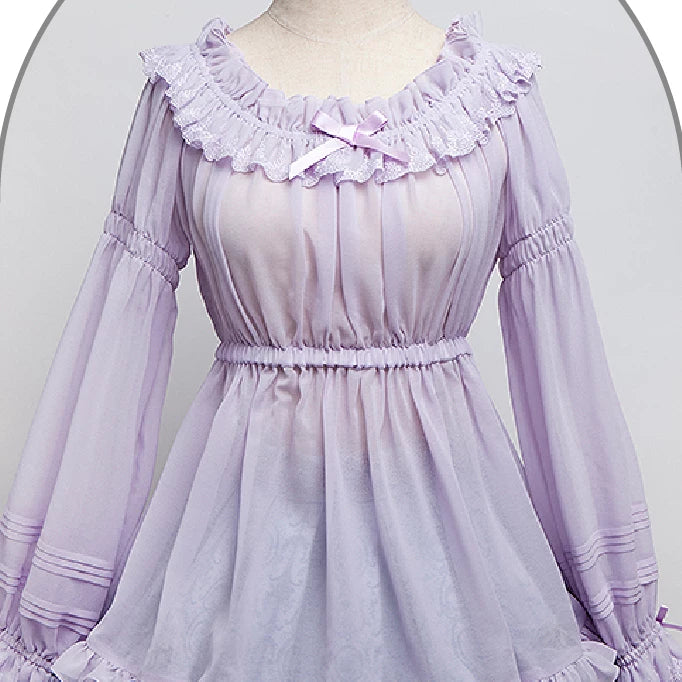 Lavender long-sleeve blouse with a gathered lace neckline and bow shown on a mannequin.