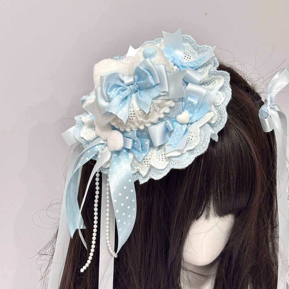 Blue cat-ear mini top hat with pale blue and white bows on a mannequin.