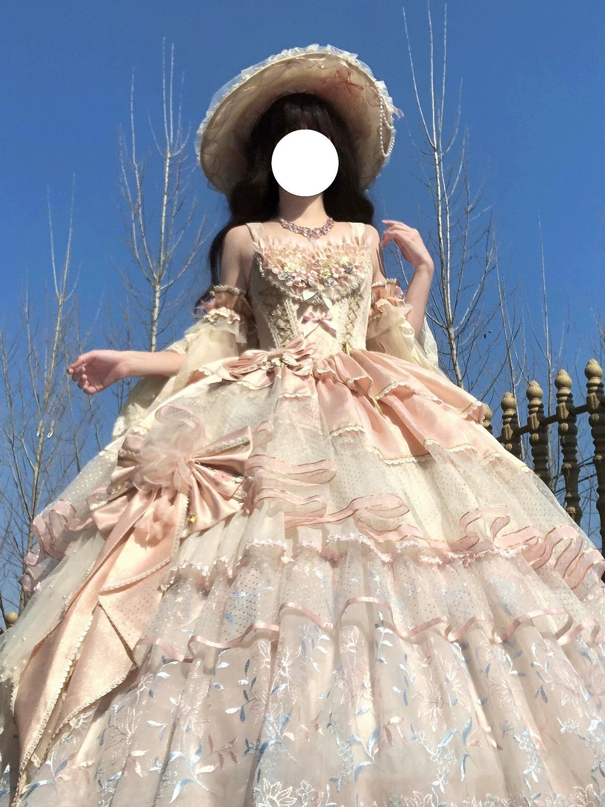 Pink Lolita evening gown with off-the-shoulder ruffled sleeves, tiered tulle skirt, and left hip satin bow, displayed with included petticoat and accessories