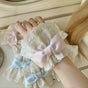 A pair of pink bow cuffs