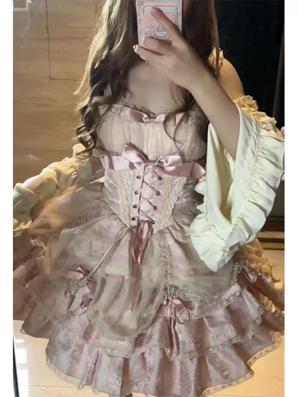 Pink ruffled OP dress with sleeve covers shown in a mirror styling photo.