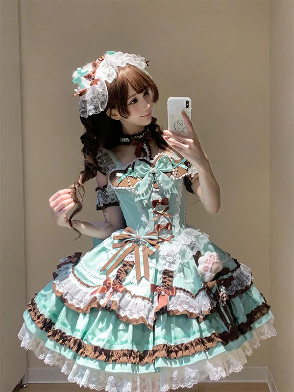 Mint-and-brown Lolita JSK dress with layered ruffles, bows, lace and a matching headpiece worn by a model.