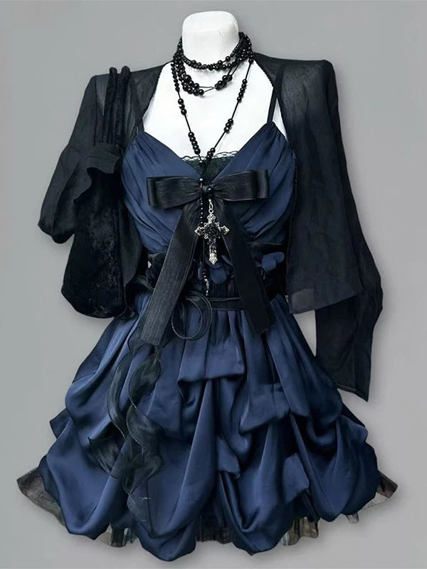 Navy dress with black sheer cardigan displayed on a mannequin in front of a piano.