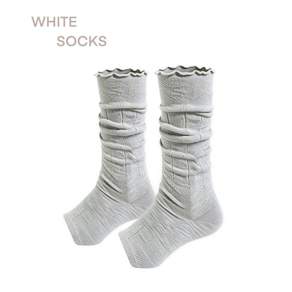 White stirrup socks with ruched mesh and ruffle cuffs styled with black shoes