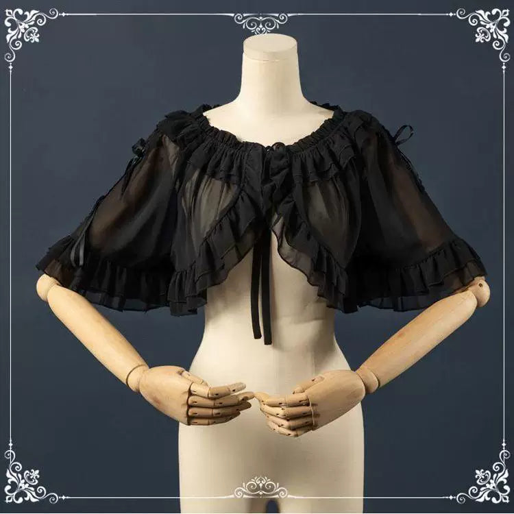 White short-sleeve sheer shawl with layered ruffles displayed on a mannequin.